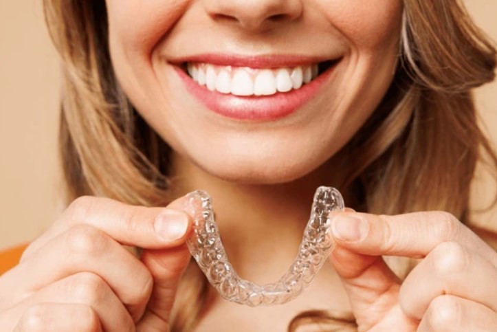 Invis tray girl https://ottawadentalcare.ca/wp-content/uploads/2025/09/Invis-tray-girl.jpg